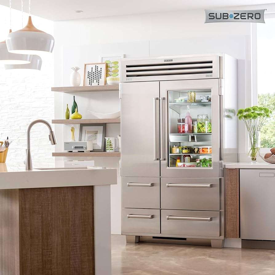 Sub-Zero built-in fridge in a stainless steel kitchen